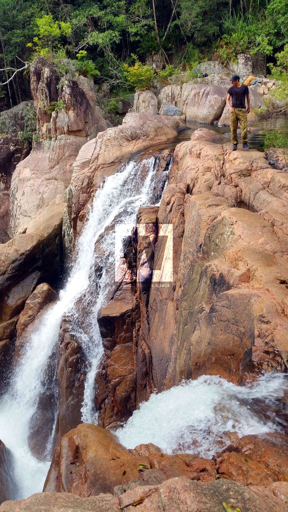 Matthew Robinson walking on top of a waterfall