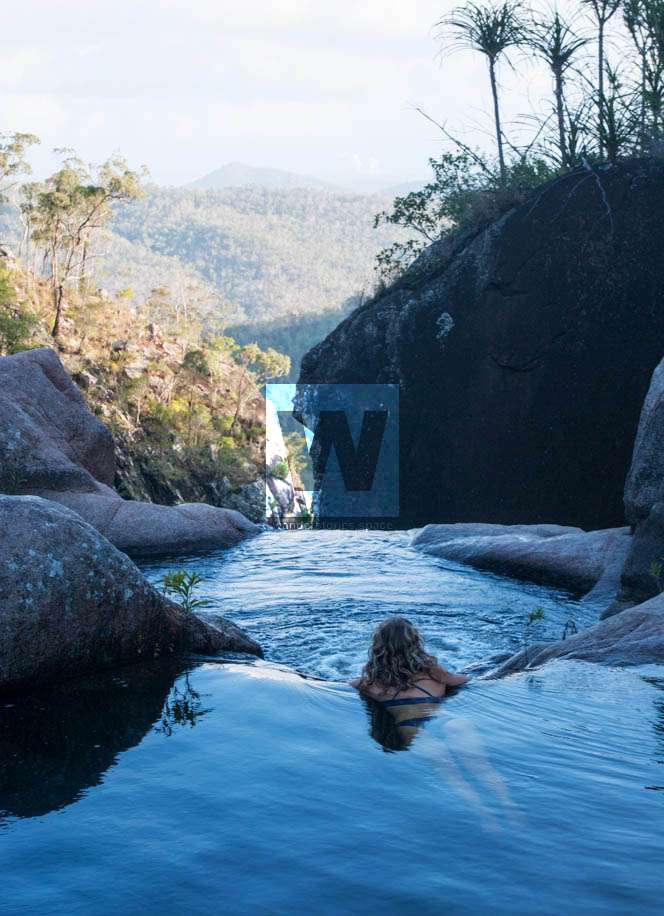 A magical, natural infinity pool above a waterfall with an amazing view