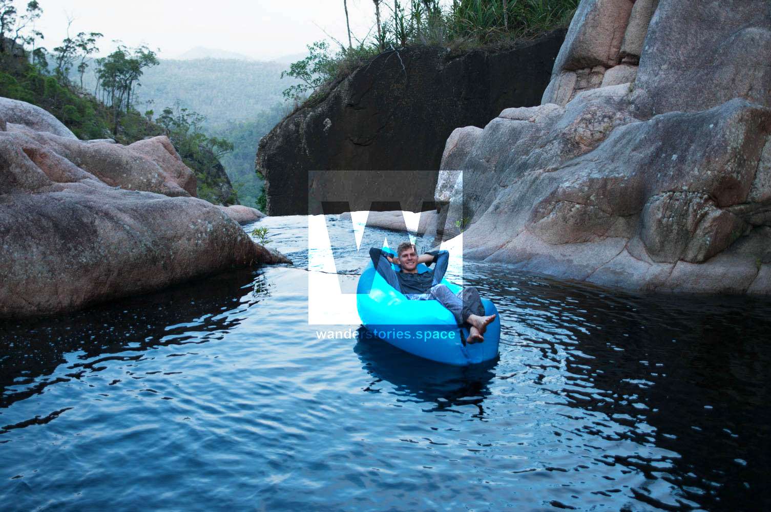 floating on water at the top of Jourama Falls