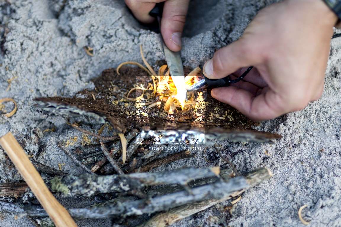Using a flint to start a fire